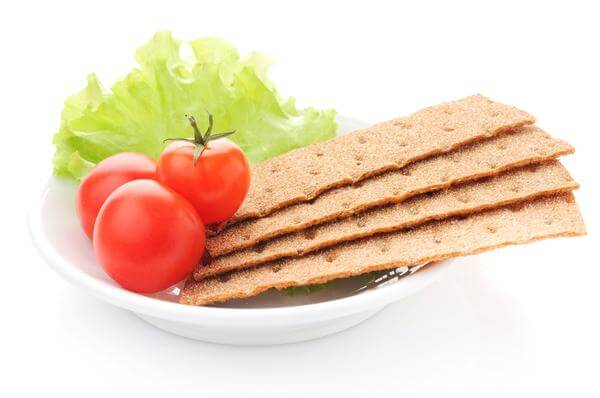 Healthy diet food with whole grain crackers, tomatoes and lettuce